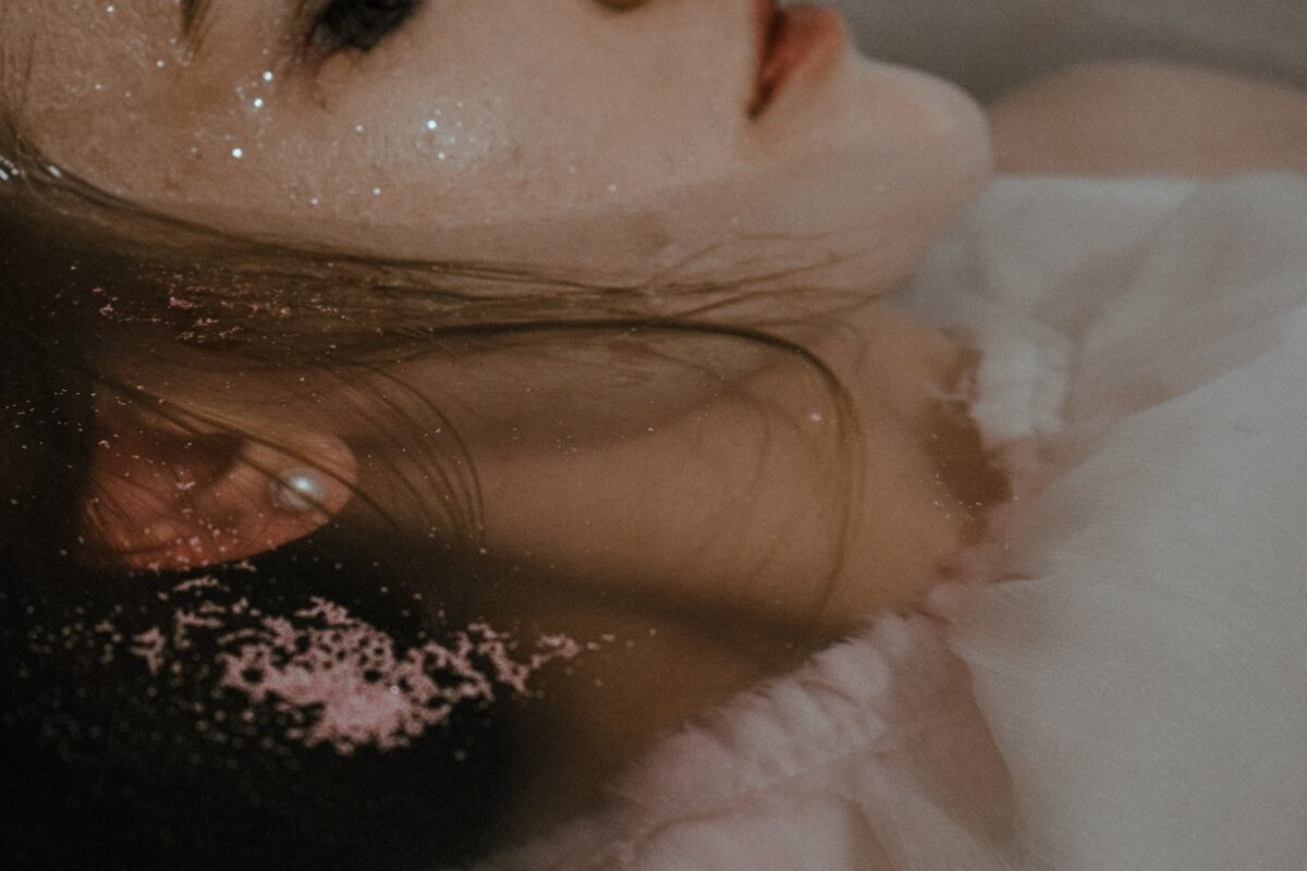 wet woman lying in bathtub
